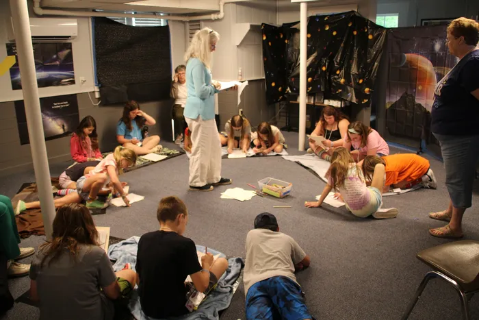 Kids on the floor making drawings