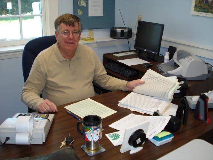Bill Morrow sitting at his desk at Brewster Baptist